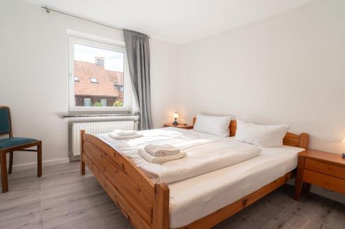 a bedroom with a large bed in a room with a window at Ferienhaus Nia in Altenau