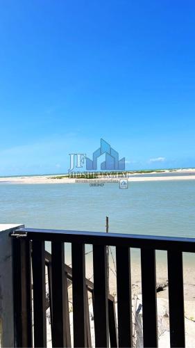 a view of the beach with a building in the water at CS1-Casa para até 8 pessoas andar superior com ar praia do sossego itamaracá PE in Itamaracá