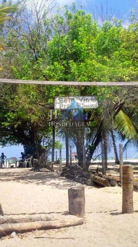 a sign on a beach with trees in the background at CS1-Casa para até 8 pessoas andar superior com ar praia do sossego itamaracá PE in Itamaracá