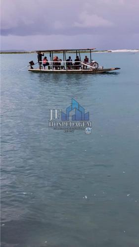 a group of people on a boat in the water at CS1-Casa para até 8 pessoas andar superior com ar praia do sossego itamaracá PE in Itamaracá
