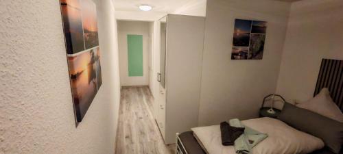a small room with a bed and a mirror at Ankerplatz in Travemünde