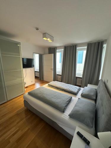 a large bedroom with a bed and a couch at Al Nafurah Apartments in Munich