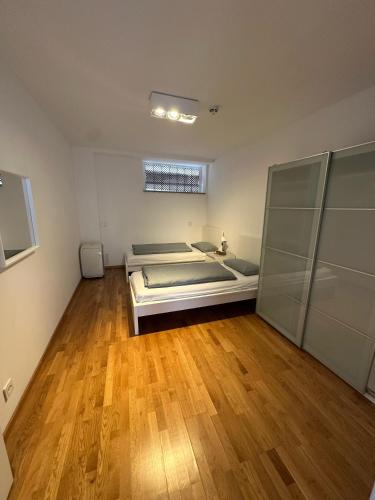 a bedroom with a bed and a wooden floor at Al Nafurah Apartments in Munich