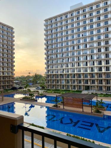 a view of a large building with a pool at Pure Bliss Getaway Condo Near Mactan Airport Lapu-Lapu in Lapu Lapu City
