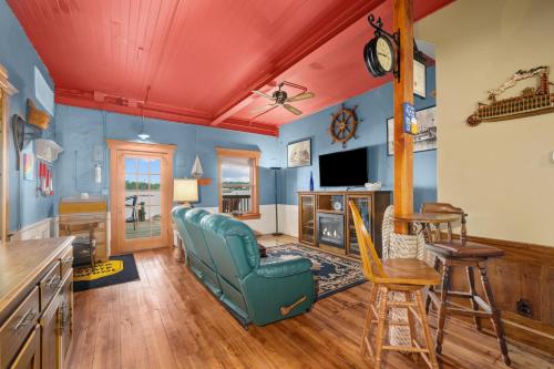 a living room with blue walls and a blue couch at Charming Cottage on the Mississipi River in Pleasant Valley
