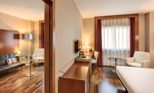 a large hotel room with a living room at Sercotel AB Rivas in Rivas-Vaciamadrid