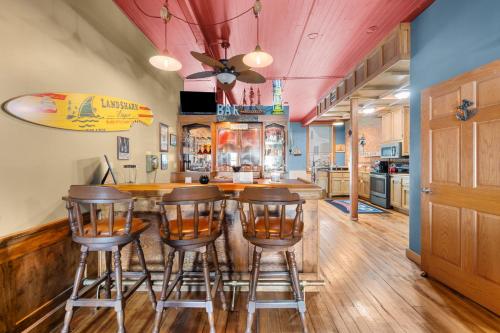 a kitchen with a bar with bar stools at Charming Cottage on the Mississipi River in Pleasant Valley