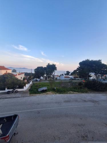 a street with a car parked on the side of the road at D and D Home Alonissos in Alonnisos Old Town