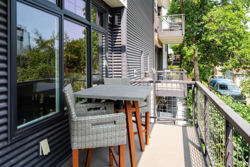 a patio with a table and chairs on a balcony at Your Downtown Urban Sanctuary - Walk to EVERYTHING in Bozeman