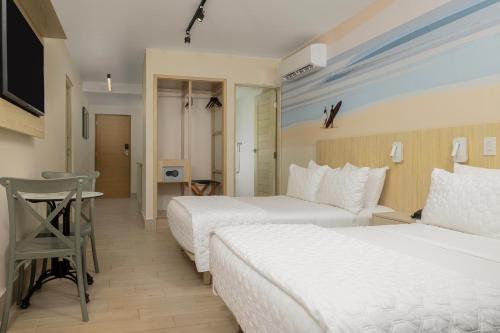 a hotel room with two beds and a desk at Radisson Riviera Panama in Punta Chame
