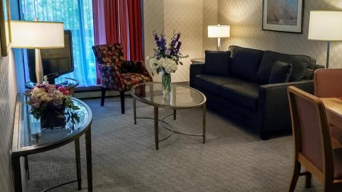 a living room with a couch and a table at Cartier Place Suite Hotel in Ottawa