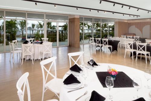 a banquet hall with white tables and chairs at Radisson Riviera Panama in Punta Chame