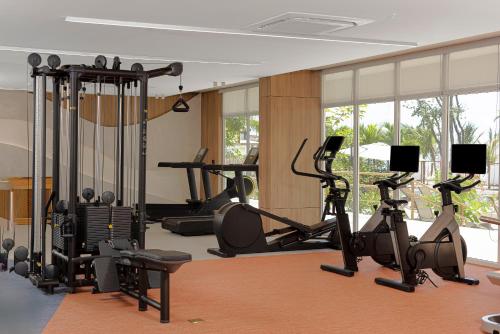a gym with several treadmills and exercise bikes at Radisson Riviera Panama in Punta Chame
