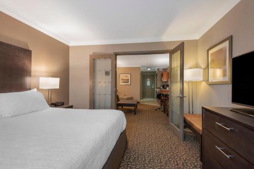 a hotel room with a bed and a flat screen tv at Best Western Plus Fernie Mountain Lodge in Fernie