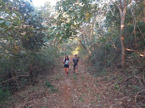 a man and woman walking down a dirt trail at Aura Bungalow 2 in Tamarindo