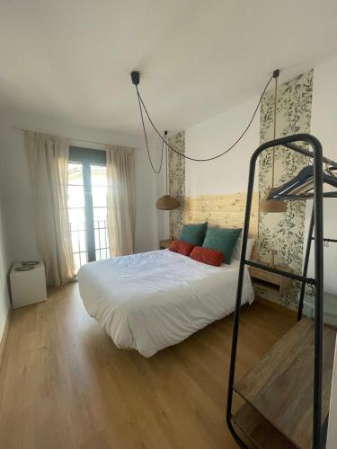 a bedroom with a white bed with a bunk ladder at Apartamento CASA PEPA in Antequera