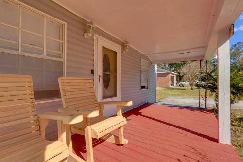 a porch with two chairs and a table at Stunning Gulfport Getaway about 1 Mi to the Beach in Gulfport