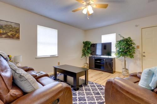 a living room with a couch and a table at Stunning Gulfport Getaway about 1 Mi to the Beach in Gulfport