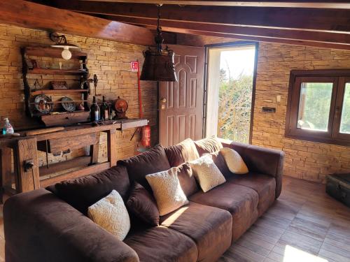 a living room with a brown couch in a room at Rifugio della Pace Piano terra e Primo Piano in Sant' Isidoro