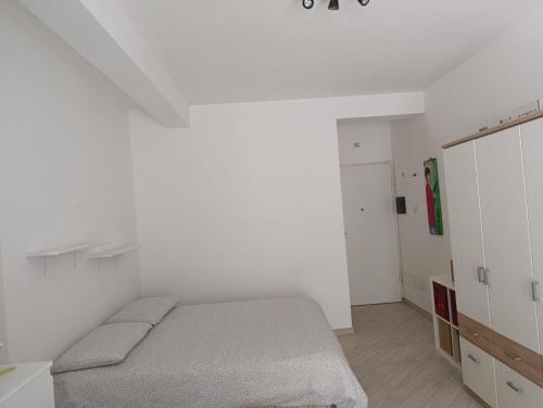 a bedroom with a bed in a white room at DolceVita Airport in Ponte Galeria