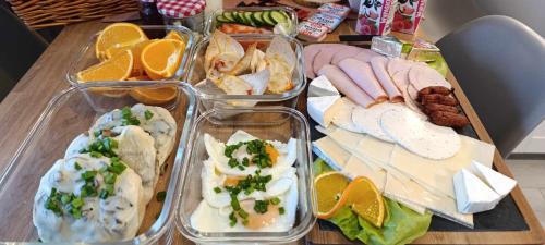 a table with four trays of different types of food at Apartamenty EDEN in Karpacz
