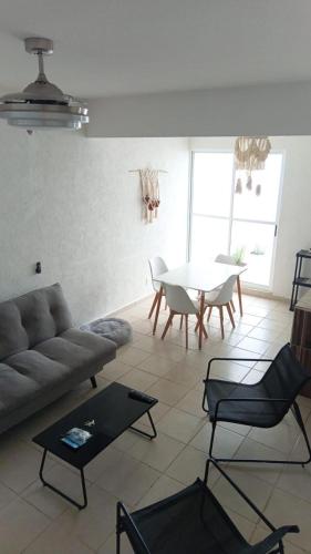 a living room with a couch and a table at Villa familiar en Playa del Carmen con alberca in Playa del Carmen