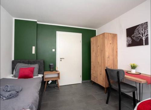 a bedroom with a bed and a desk and a table at Livemore24 - Space in Oer-Erkenschwick WLAN in Oer-Erkenschwick