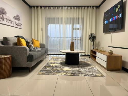 a living room with a couch and a table at Ambience Defined in Randjesfontein