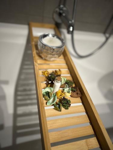 a wooden table with a tray of food on it at Wellness Spa Suite by the Opera in Budapest