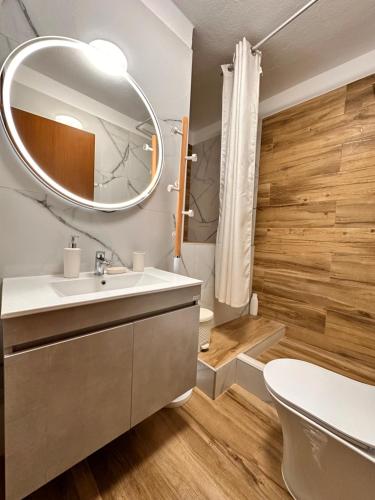 a bathroom with a sink and a mirror at Nikiti Spathies Resort - Maizonette at Nikiti Village in Nikiti