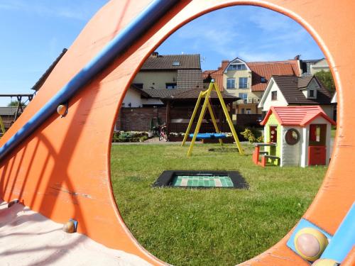 a mirror reflection of a playground with a slide at Elizabeth Łeba - Pokoje Gościnne in Łeba