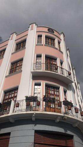 a tall building with balconies on top of it at Hotel Sucre in Quito