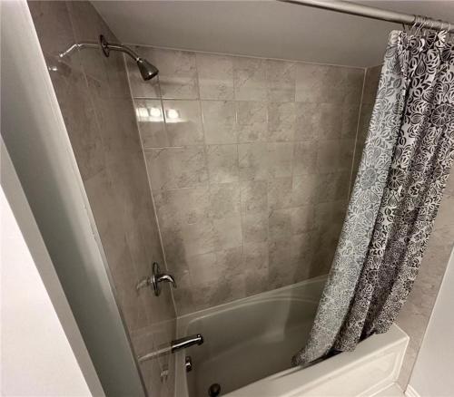 a shower in a bathroom with a shower curtain at Lovely 2 bedroom 2 bath in Ottawa