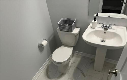a bathroom with a toilet and a sink at Lovely 2 bedroom 2 bath in Ottawa