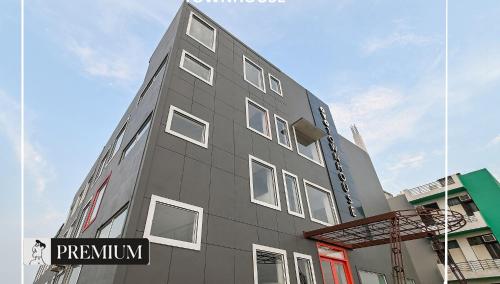 a gray building with a street sign in front of it at Townhouse D- Knowledge Park III in Noida
