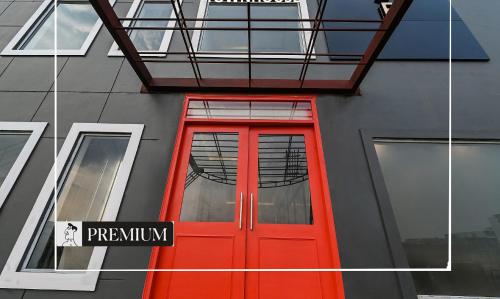 a red door on the side of a building at Townhouse D- Knowledge Park III in Noida