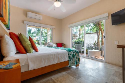 a bedroom with a bed and a large window at Rojo Manglar Acapulco in Acapulco