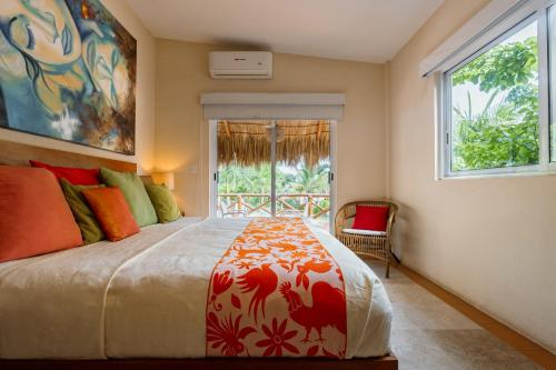 a bedroom with a bed and a window at Rojo Manglar Acapulco in Acapulco