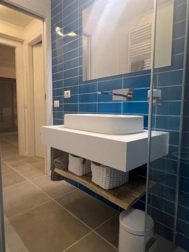 a bathroom with a white sink and a mirror at TheView108, Rena Bianca in Baja Sardinia