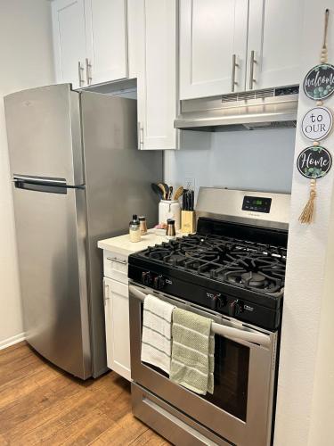 a kitchen with a stainless steel stove and refrigerator at Hollywood Blvd Studio FREE DESIGNATED PARKING & WIFI in Los Angeles