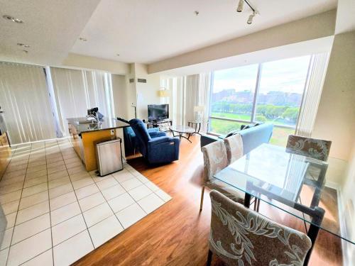 a living room with a glass table and chairs at Furnished Corporate Apartments by Charles River Park in Boston