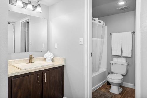 a white bathroom with a sink and a toilet at Luxury Tempe Retreat Pool Gym WiFi in Tempe