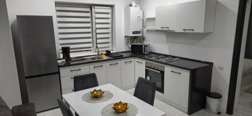 a small kitchen with a table and a counter top at C&C apartamente in Sîngeorgiu de Mureş