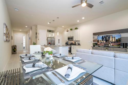 a living room with a glass table and a couch at Magic Villa Orlando in Orlando