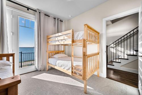 a bedroom with bunk beds and a view of the ocean at Charming Lake House Retreat In Rowlett in Rowlett