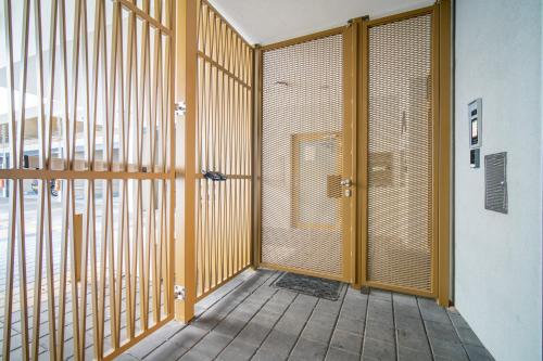 a room with a wooden door and a room with a window at apartino - FREE parking, 10 minutes walk to city centre, nespresso, netflix in Brno
