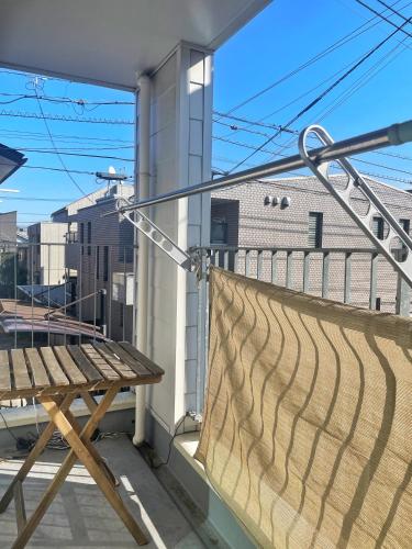 a balcony with a wooden bench and a railing at Chill Fortuna Shimokitazawa Tokyo in Tokyo