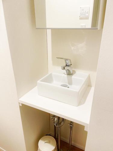 a bathroom with a white sink and a toilet at Chill Fortuna Shimokitazawa Tokyo in Tokyo