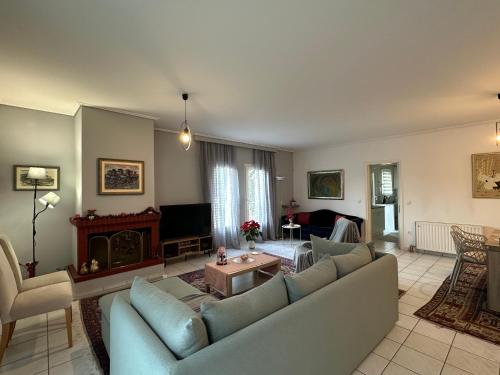 a living room with a couch and a table at Ria's Home in Athens