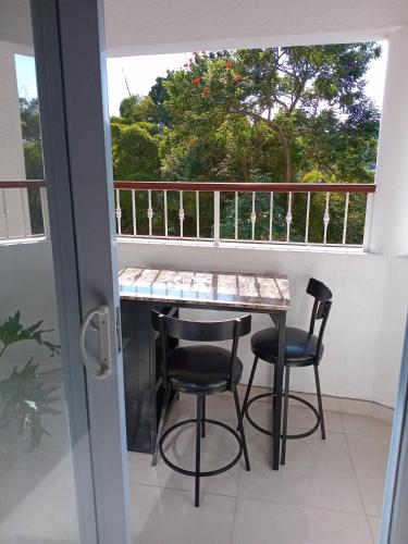 a balcony with a table and two chairs at Gorgeous 1 Bedroom Apartment in the Kingston Hills in Kingston
